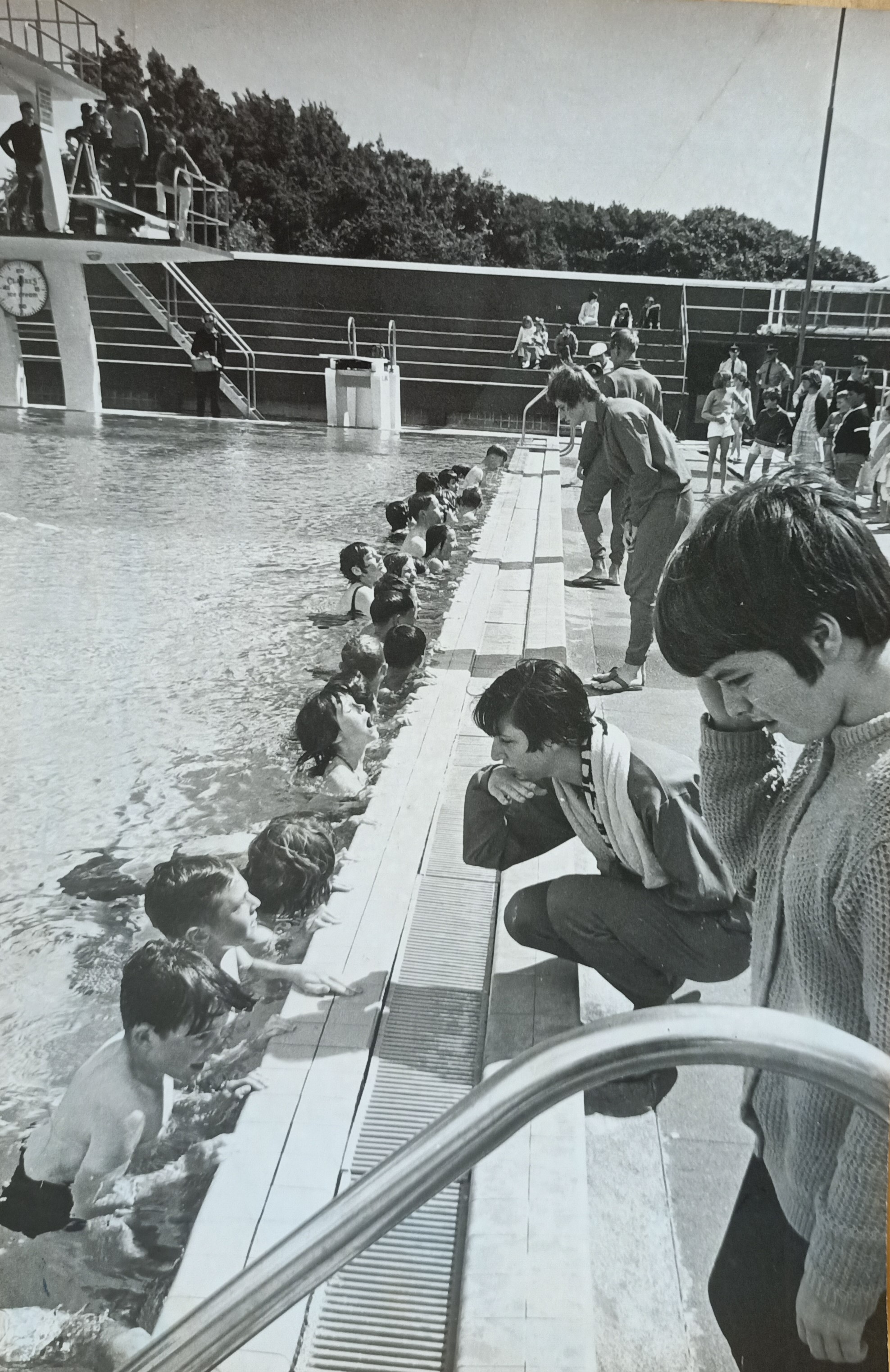 Tony Keenan and Hilary Keenan (nee Kerr) sitting alongside the Naenae Pool